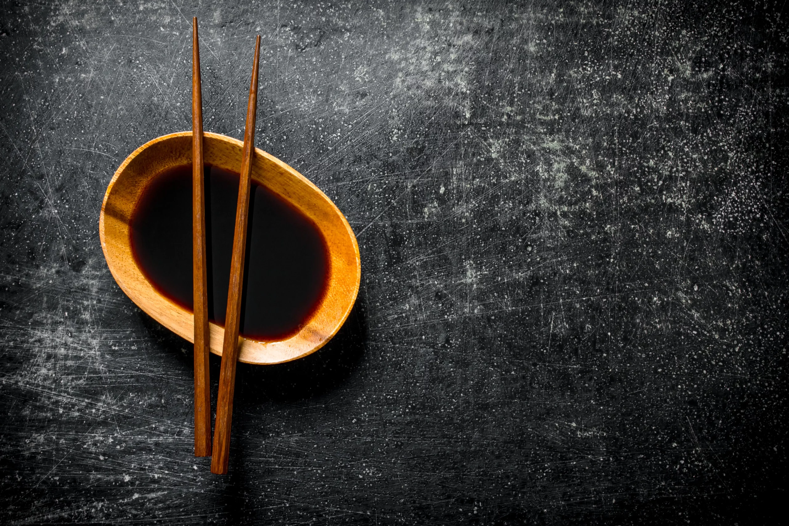 soy sauce in a bowl with chopsticks